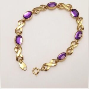 AVON: Gold tone faceted amethyst color rhinestones bracelet, length 7 1/4 in